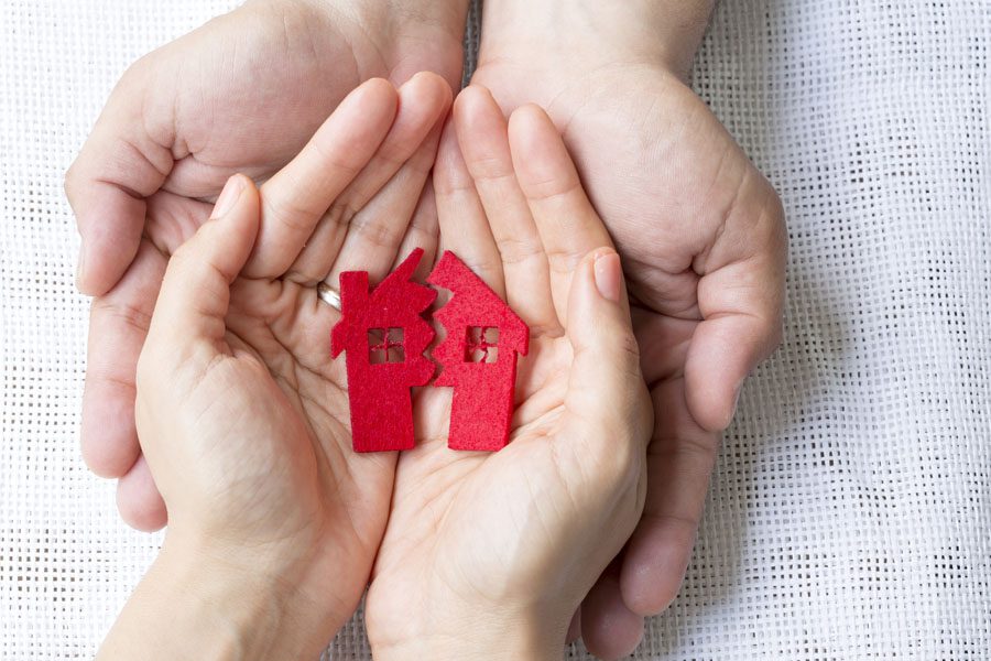 Earthquake Insurance - Hands Holding a Broken Home